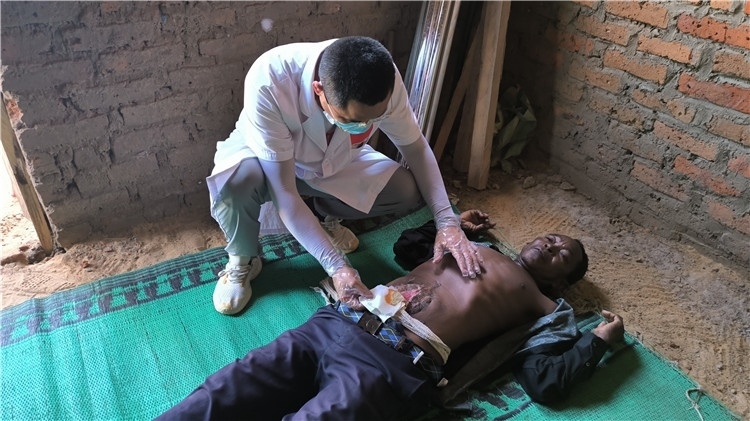 圖為南昌大學(xué)第二附屬醫(yī)院胃腸外科主治醫(yī)師周智勇檢查切口疝患者。中國駐乍得醫(yī)療隊供圖