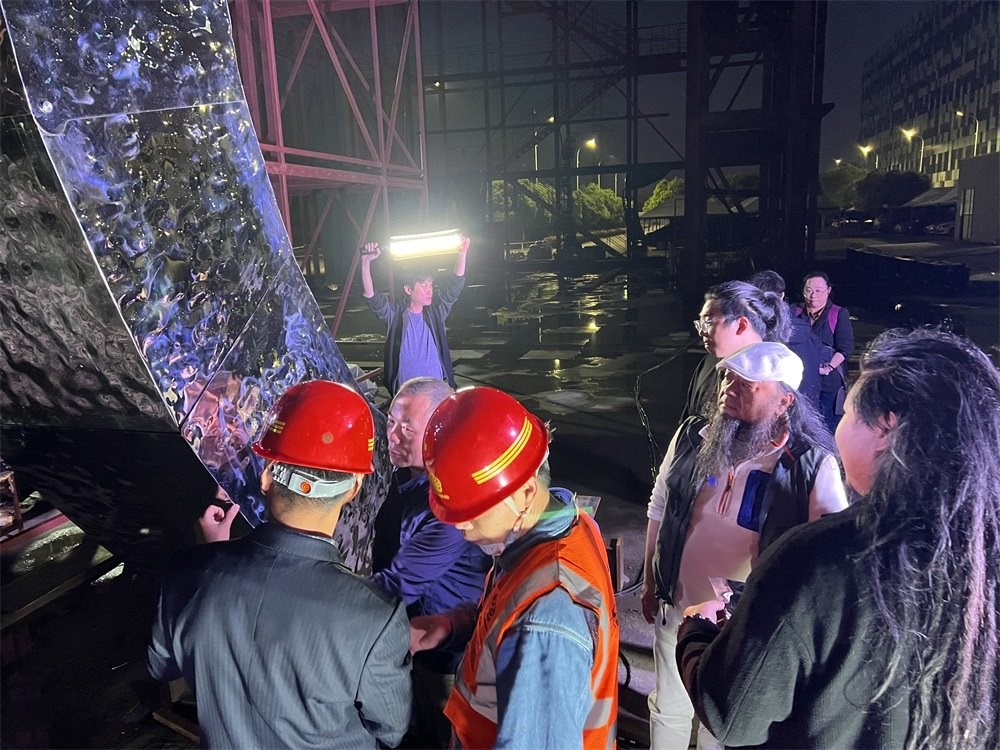 林崗（右二）和團(tuán)隊(duì)查看主火炬制作進(jìn)度。受訪(fǎng)者供圖