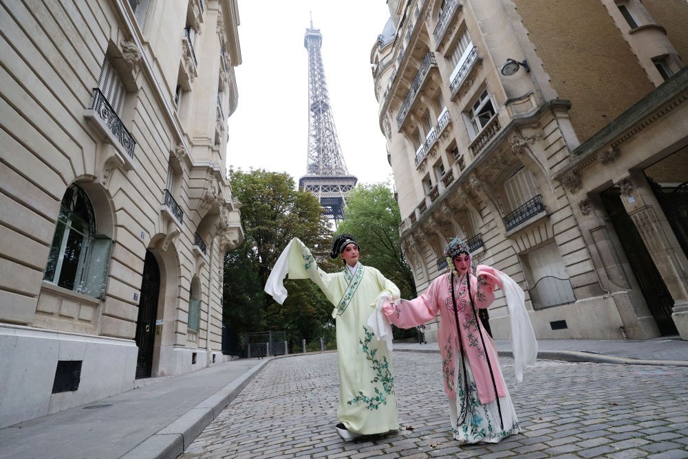 2023年9月13日，江蘇省演藝集團昆劇院院長施夏明（左）和江蘇省演藝集團昆劇院國家一級演員孔愛萍在法國巴黎埃菲爾鐵塔附近參加昆曲快閃。新華社記者 高靜 攝