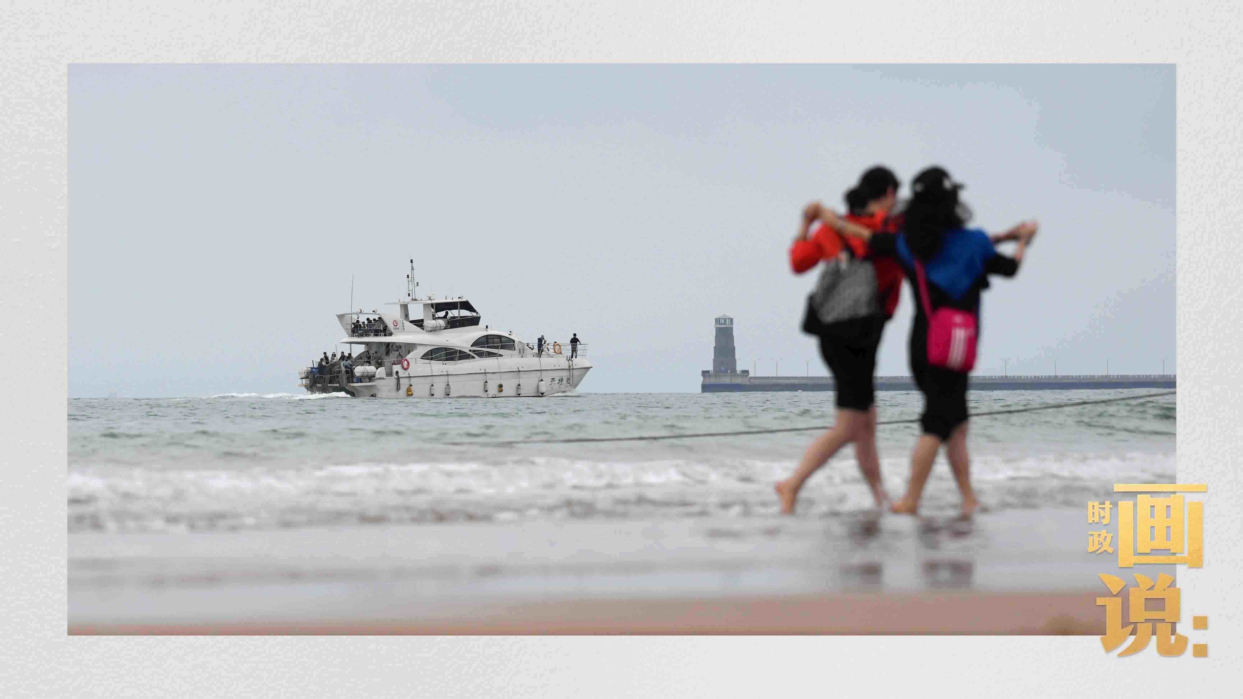 △日照陽光海岸綠道上的萬平口景區(qū)，一對游客在海浪中翩然起舞。
